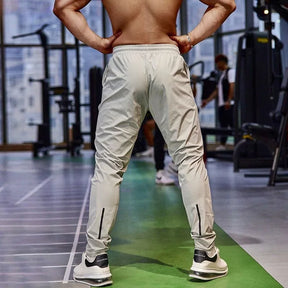 Calça de corrida masculina, calça esportiva, calça com cintura elástica, calça de poliéster e spandex, calça para treino, calça ajustada para corrida, moda fitness masculina, calça SHEDAO, calça de alta performance