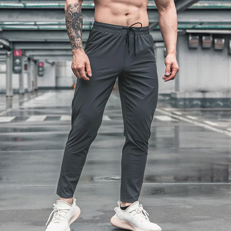 Calça de corrida masculina, calça esportiva, calça com cintura elástica, calça de poliéster e spandex, calça para treino, calça ajustada para corrida, moda fitness masculina, calça SHEDAO, calça de alta performance
