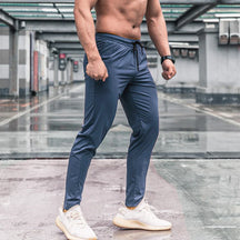 Calça de corrida masculina, calça esportiva, calça com cintura elástica, calça de poliéster e spandex, calça para treino, calça ajustada para corrida, moda fitness masculina, calça SHEDAO, calça de alta performance