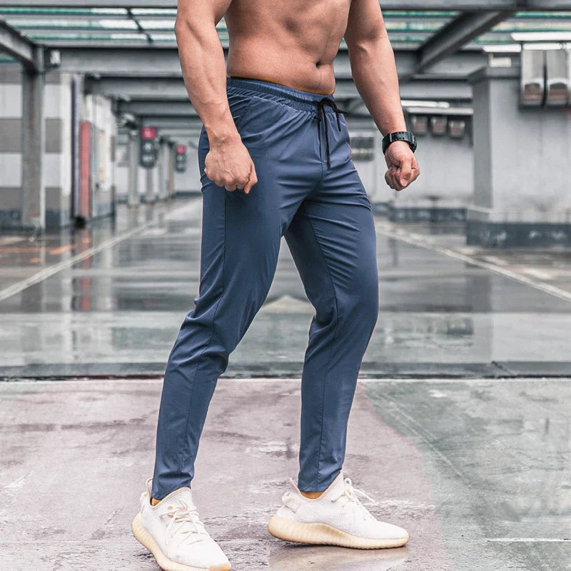 Calça de corrida masculina, calça esportiva, calça com cintura elástica, calça de poliéster e spandex, calça para treino, calça ajustada para corrida, moda fitness masculina, calça SHEDAO, calça de alta performance