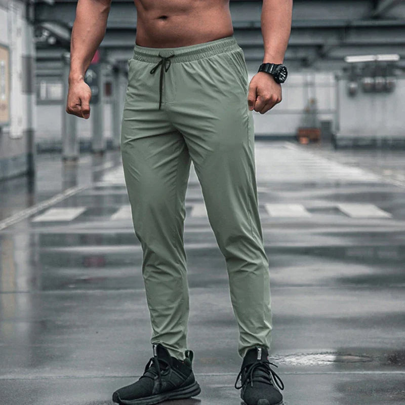 Calça de corrida masculina, calça esportiva, calça com cintura elástica, calça de poliéster e spandex, calça para treino, calça ajustada para corrida, moda fitness masculina, calça SHEDAO, calça de alta performance