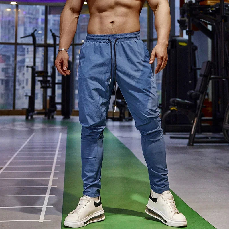 Calça de corrida masculina, calça esportiva, calça com cintura elástica, calça de poliéster e spandex, calça para treino, calça ajustada para corrida, moda fitness masculina, calça SHEDAO, calça de alta performance