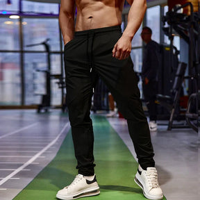 Calça de corrida masculina, calça esportiva, calça com cintura elástica, calça de poliéster e spandex, calça para treino, calça ajustada para corrida, moda fitness masculina, calça SHEDAO, calça de alta performance