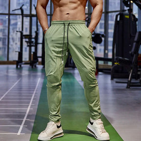 Calça de corrida masculina, calça esportiva, calça com cintura elástica, calça de poliéster e spandex, calça para treino, calça ajustada para corrida, moda fitness masculina, calça SHEDAO, calça de alta performance