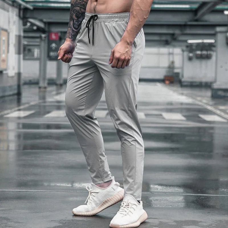Calça de corrida masculina, calça esportiva, calça com cintura elástica, calça de poliéster e spandex, calça para treino, calça ajustada para corrida, moda fitness masculina, calça SHEDAO, calça de alta performance